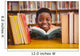 Cute boy reading book in library Wall Mural