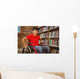Portrait of boy sitting in wheelchair at library Wall Mural