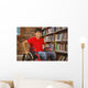 Portrait of boy sitting in wheelchair at library Wall Mural
