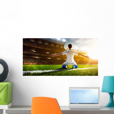 Soccer Player In Action Wall Decal shown on a wall
