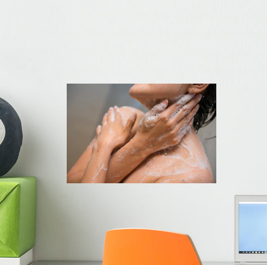 girl cleaning her body with shower cream Wall Mural