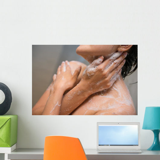 girl cleaning her body with shower cream Wall Mural
