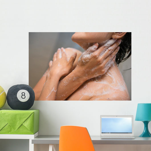 girl cleaning her body with shower cream Wall Mural
