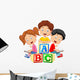 Children reading book and sitting on alphabet blocks Wall Decal