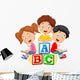 Children reading book and sitting on alphabet blocks Wall Decal