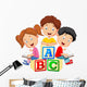 Children reading book and sitting on alphabet blocks Wall Decal
