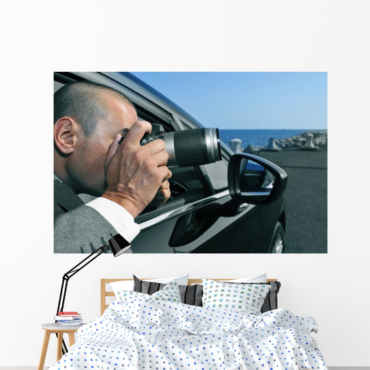 detective or paparazzi taking photos from inside a car Wall Mural