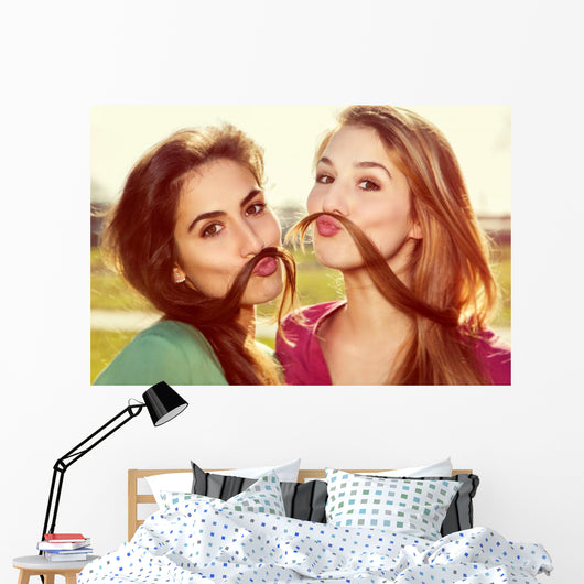 Two girls kid around Wall Mural