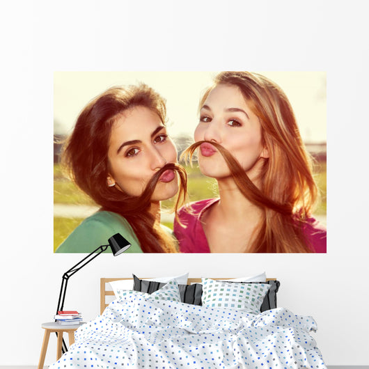 Two girls kid around Wall Mural