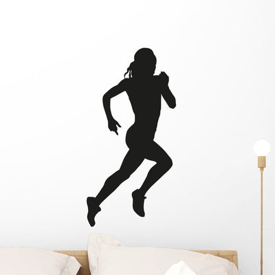 Running Woman Silhouette Wall Decal shown on a wall