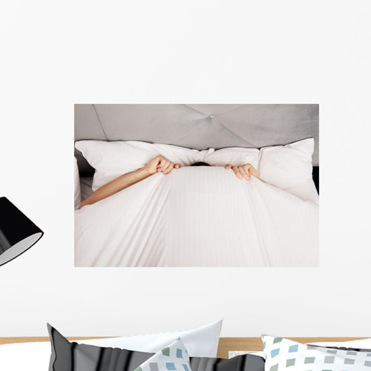 Man Hiding Bed under Wall Decal