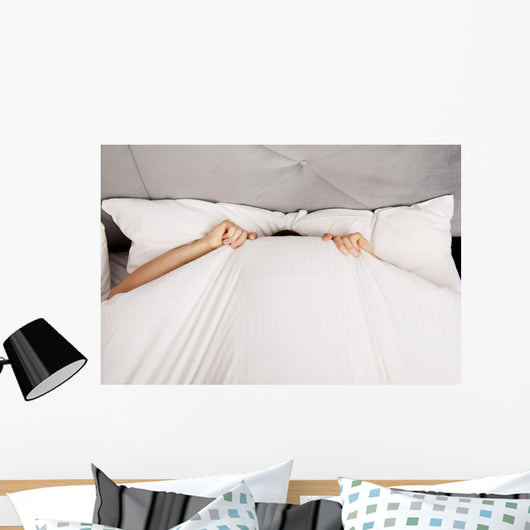 Man Hiding Bed under Wall Decal