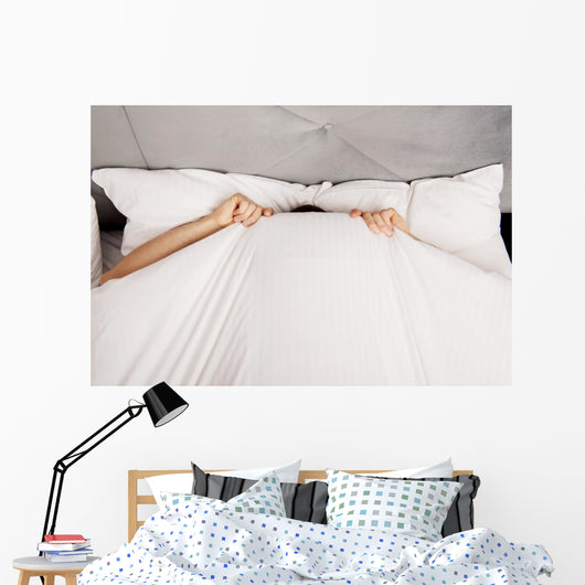Man Hiding Bed under Wall Decal