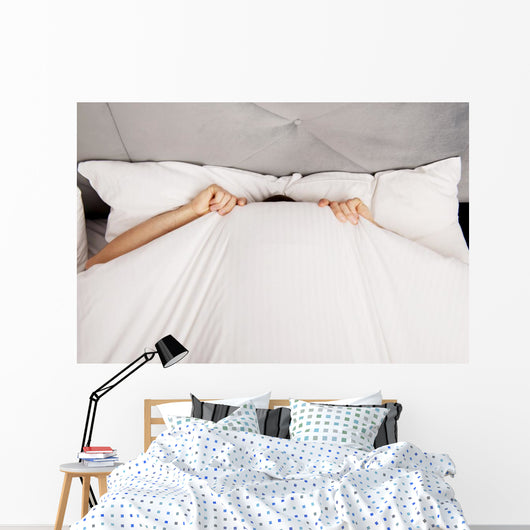Man Hiding Bed under Wall Decal