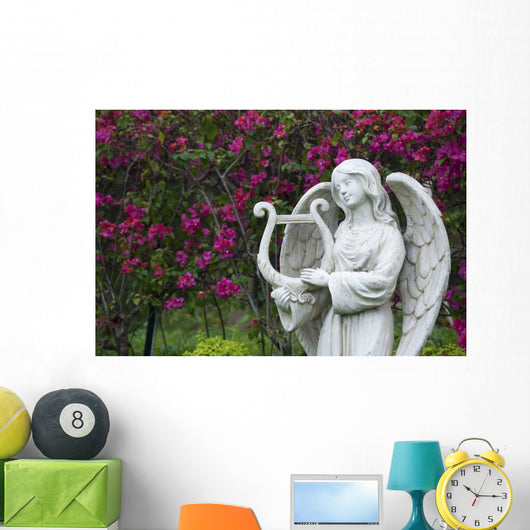 White marble statue of angel in flower garden Wall Mural