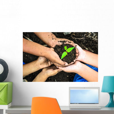 Child Holding Young Plant Wall Decal shown on a wall