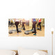 Group of women making step aerobics from the backside Wall Mural