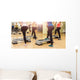 Group of women making step aerobics from the backside Wall Mural