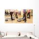 Group of women making step aerobics from the backside Wall Mural