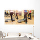 Group of women making step aerobics from the backside Wall Mural