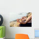The woman meditating in a yoga pose on the tropical beach. Wall Mural