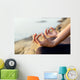 The woman meditating in a yoga pose on the tropical beach. Wall Mural