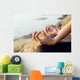 The woman meditating in a yoga pose on the tropical beach. Wall Mural