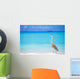 Grey heron standing on white beach on Maldives island Wall Mural