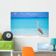 Grey heron standing on white beach on Maldives island Wall Mural