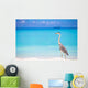 Grey heron standing on white beach on Maldives island Wall Mural