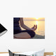The woman meditating in a yoga pose on the tropical beach. Wall Mural