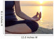 The woman meditating in a yoga pose on the tropical beach. Wall Mural