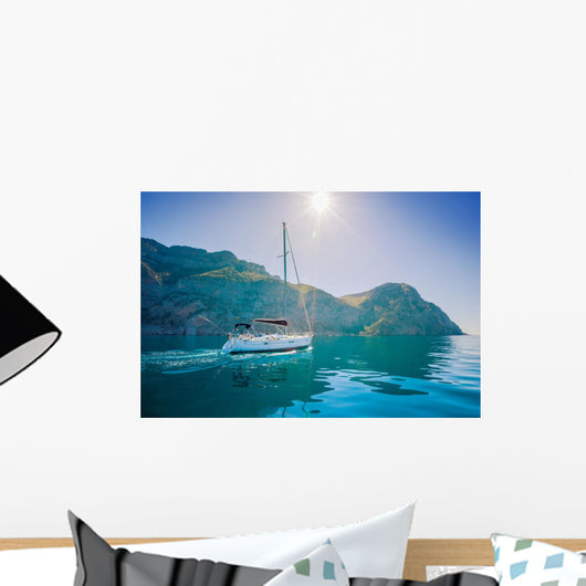 Yacht sailing along the shore the sea in calm weather. Wall Mural