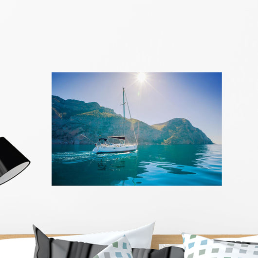 Yacht sailing along the shore the sea in calm weather. Wall Mural