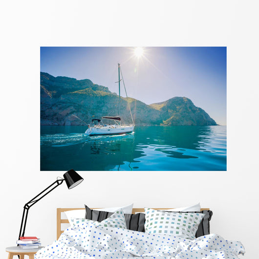 Yacht sailing along the shore the sea in calm weather. Wall Mural