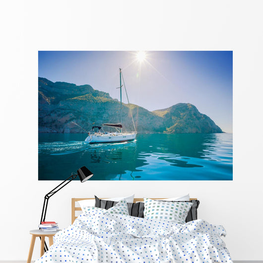 Yacht sailing along the shore the sea in calm weather. Wall Mural