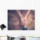Man and woman holding hands at a table Wall Mural