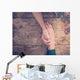 Man and woman holding hands at a table Wall Mural