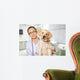 Veterinarian. Vet using technology with a little dog - isolated Wall Mural