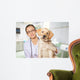Veterinarian. Vet using technology with a little dog - isolated Wall Mural