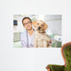 Veterinarian. Vet using technology with a little dog - isolated Wall Mural