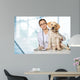 Veterinarian. Vet using technology with a little dog - isolated Wall Mural