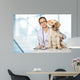 Veterinarian. Vet using technology with a little dog - isolated Wall Mural