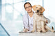 Veterinarian. Vet using technology with a little dog - isolated Wall Mural