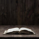 Image of an old  Holy Bible on wooden background on a wooden background in a dark space Wall Mural