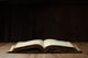 Image of an old Holy Bible on wooden background in a dark space Wall Mural