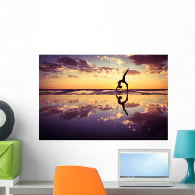Silhouetted Woman Practicing Yoga at Sunset Wall Decal shown on a wall
