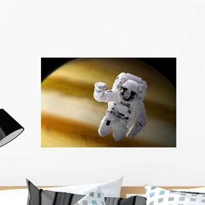 Astronaut Floating Space above Wall Decal shown on a wall