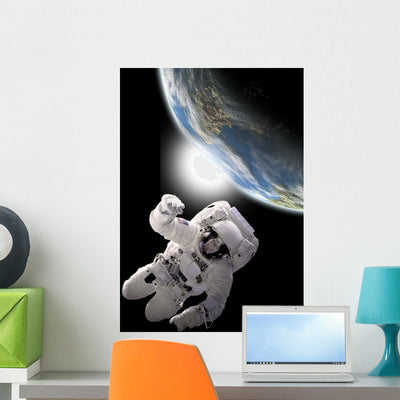 Astronaut Floating Outer Space Horizontal Wall Decal shown on a wall