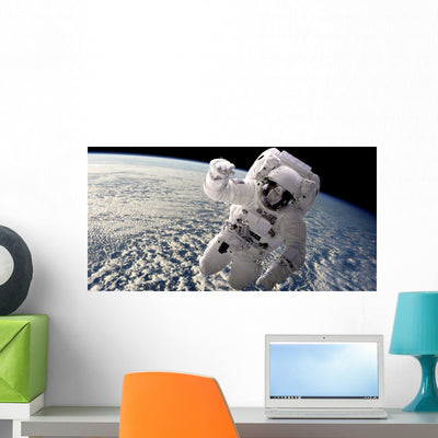 Artist's Concept Astronaut Floating Clouds Wall Decal shown on a wall